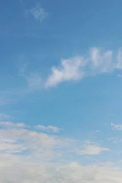 Space of clear sky with soft scattered clouds, creating a feeling of calm Stock Photos