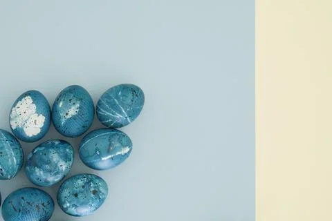 Space easter eggs on yellow-blue background with copy space, top view, flat lay Stock Photos