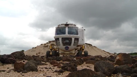 Space Exploration Vehicle driving over rocks Stock Footage 99085708