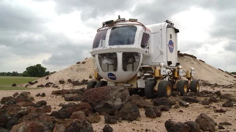 Space Exploration Vehicle driving over rocks Stock Footage 99085977