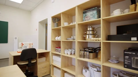 Space features sewing machines on tables near shelving units Stock Footage 333904358