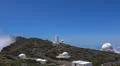Space observatory telescope on mountain peak with clouds below in La Palma Photo