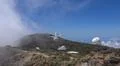 Space observatory telescope on mountain peak with clouds below in La Palma Photo