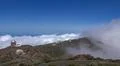 Space observatory telescope on mountain peak with clouds below in La Palma Photo