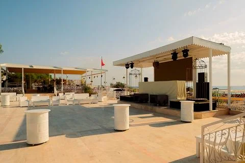 Space by the ocean with seating arranged for  event.  stage is set up with eq Stock Photos