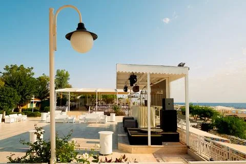 Space by the ocean with seating arranged for  event.  stage is set up with eq Stock-Fotos