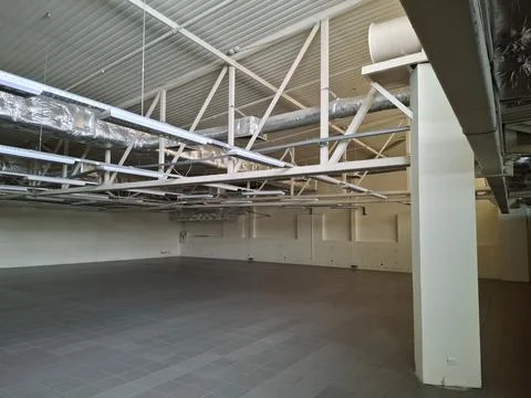 Space for rent in large supermarket. Empty store or warehouse Stock Photos
