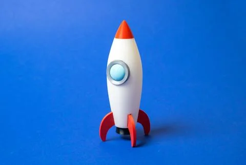 Space rocket on blue background. Concept of space aerotechnics. Advertising,  Stock Photos
