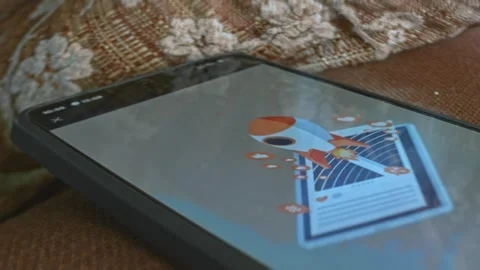 Space rocket emerging from a tablet themed graphic presentation on smartphone Stock Footage 303425143