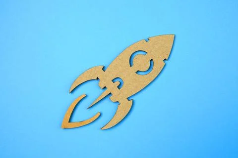 Space rocket flying in space cut paper craft on blue paper background. Stock Photos
