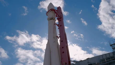 Space rocket at the launch complex against a blue sky with clouds and sun rays  Stock Footage 187847618
