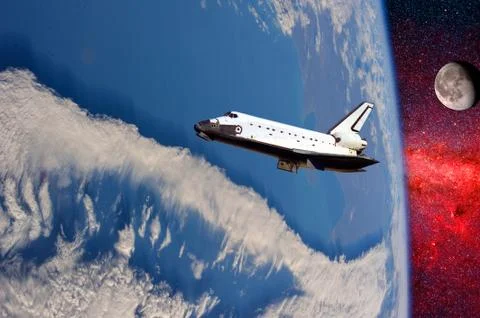 Space ship shuttle on the earth orbit in atmosphere. flying in outer space. E Stock Photos
