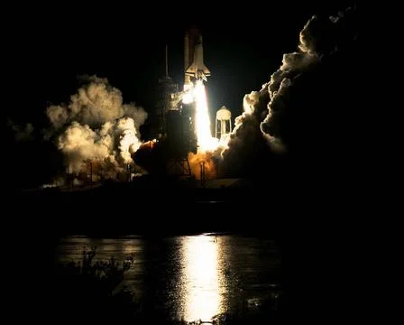 The Space Shuttle Atlantis blazes through the night sky to begin the STS-8... Stock Photos