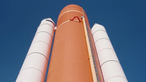 Space Shuttle External Tank and Solid Rocket Boosters Against Blue Sky Stock Footage 337904169