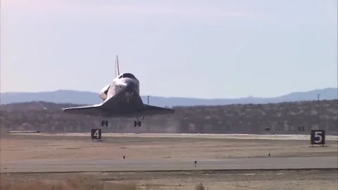 Space shuttle landing on runway after completing its mission. Stock Footage 346504277