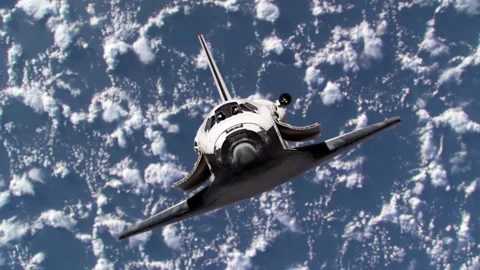Space shuttle orbiting in space with planet earth in the background. Stock Footage 346798042