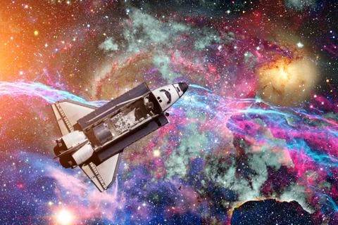 Space Shuttle over galaxy and space nebula. Stock Photos
