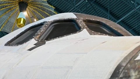 Space shuttle parked indoors with large windows visible in background. Stock Footage 339386203