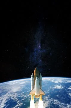 Space Shuttle takes off into space. Elements of this image furnished by NASA. Stock Photos