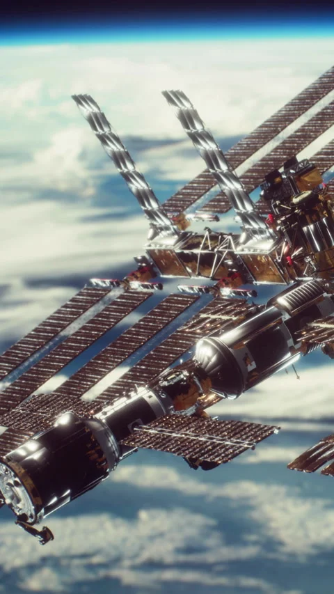 Space station orbits Earth in the vastness of space with clouds below Stock Footage 344963346
