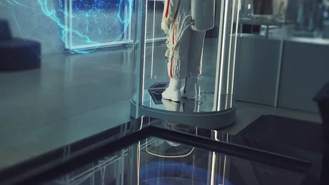 Space Suit on the Background of a Hologram of Rotating Earth Stockbeeldmateriaal 129859770