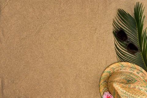 Space for text, beach theme on sand background. Hat, sunglasses on sand backg Stock Photos