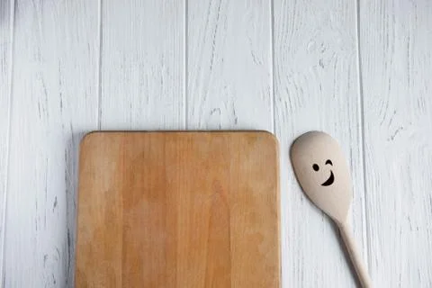 Space for text in the form of an old kitchen board on a white wooden backgrou Stock Photos