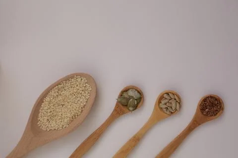Space for text on a white background. Organic natural pumpkin, flax, sesame Stock Photos