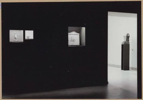 Space with two wall vitrins with three objects and a passage; 5000 years o... Stock Photos