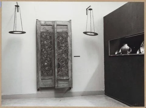 Space with various objects in a display case, two processed door wings and... Stock Photos