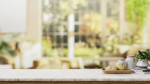 A space on a white marble table with a blurred background of a bright livin.. Stock Illustration