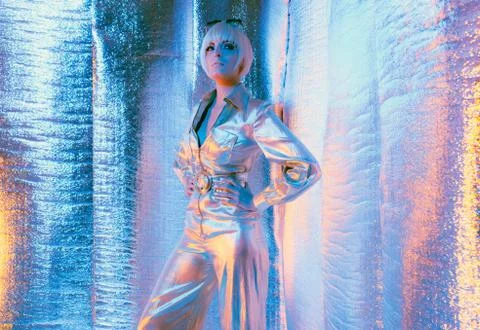Space woman wearing jump suit and sunglasses. Standing in reflective solar ro Stock Photos