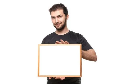 Space for your text or ad. Guy in black t-shirt in studio. Man with expressio Stock Photos