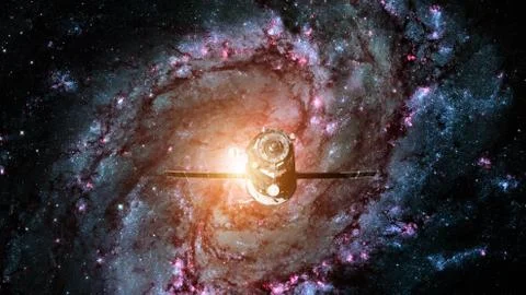 Spacecraft Progress orbiting the spiral galaxy. Stockfoto's