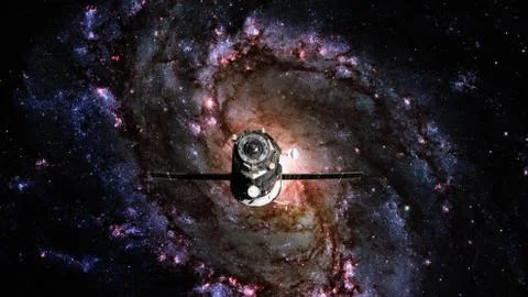 Spacecraft Progress orbiting the spiral galaxy. Stock Photos