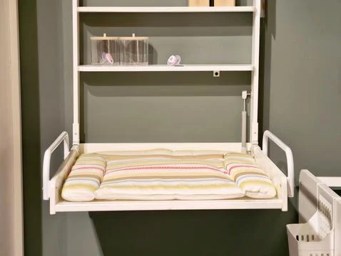 Spaceefficient baby changing setup. Functional and attractive baby care are.. 库存照片