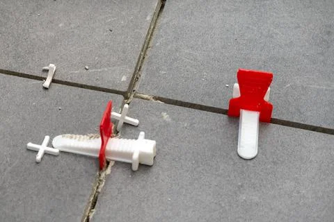 Spacer between floor tiles for consistent grout gap Stock Photos