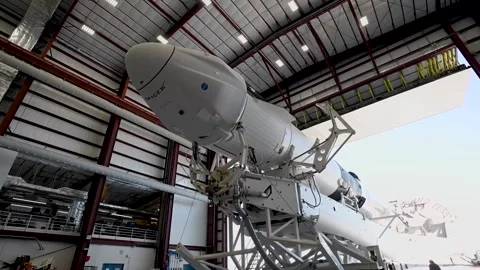 SpaceX Cargo Dragon spacecraft atop Falcon 9 rocket being rolled out for launch Stock Footage 289723429