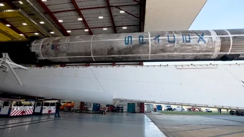 SpaceX Cargo Dragon spacecraft, positioned atop Falcon 9 rocket being rolled out Stock Footage 289723428