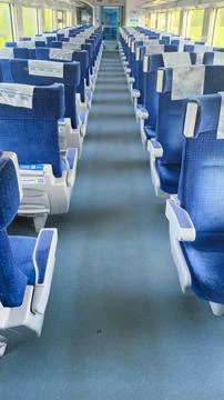 Spacious and Comfortable Train Interior with Blue Seating and Clean Aisles for a Stock Photos