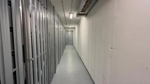 A Spacious and Long Corridor Featuring Multiple Storage Units in a Modern F.. Stock Photos