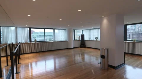 A spacious and modern office interior design that maximizes natural light 스톡 동영상 295077480