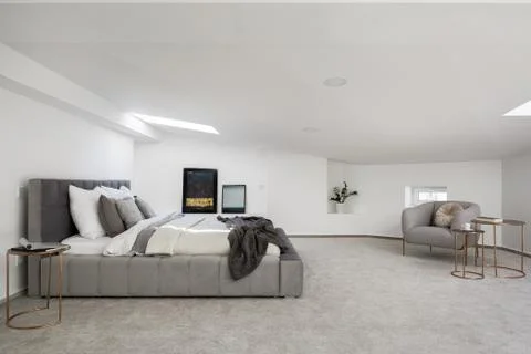 Spacious attic bedroom Stock Photos
