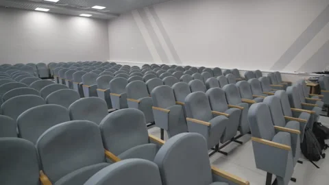 Spacious auditorium with chair rows and pastel walls Stock Footage 309766013