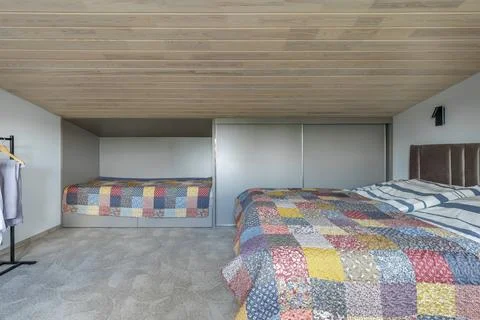 Spacious Bedroom Interior with Multiple Beds and Wardrobe Stock Photos