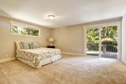 Spacious bedroom interior with walkout deck Stock Photos