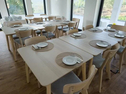 Spacious breakfast dining room with tables ready for guests Stock Photos