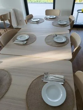Spacious breakfast dining room with tables ready for guests Stock Photos