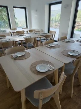 Spacious breakfast dining room with tables ready for guests Stock Photos