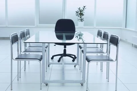 Spacious, bright, modern office space. Glass table. A place to learn at work. Stock Photos
